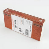 Eine braune Schachtel mit Lederstruktur, die einem Buch ähnelt, enthält das „Ackermann Nähgarn Leather Mix 6x 120 m Stärke 60“ von ACKERMANN®. Auf dem weißen Etikett sind Produktdetails und ein Barcode aufgedruckt, wodurch es eine perfekte Ergänzung für Ihre Leder-Nähgarn-Sammlung darstellt.