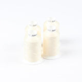 Vier Spulen ACKERMANN® Ackermann Bauschgarn Nähgarn Stärke 120 (Farbe 5209 beige, jeweils 1.000 Meter) sind auf weißem Hintergrund quadratförmig angeordnet.