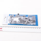 Ein verpacktes ACKERMANN®-Füßchenset für die Gritzner 788 Overlock (fünfteilig) ist auf weißem Hintergrund neben einem Lineal als Größenvergleich abgebildet; es ist etwa 22 cm lang. Dieses Set enthält Original-Ersatzteile, um eine optimale Leistung zu gewährleisten.